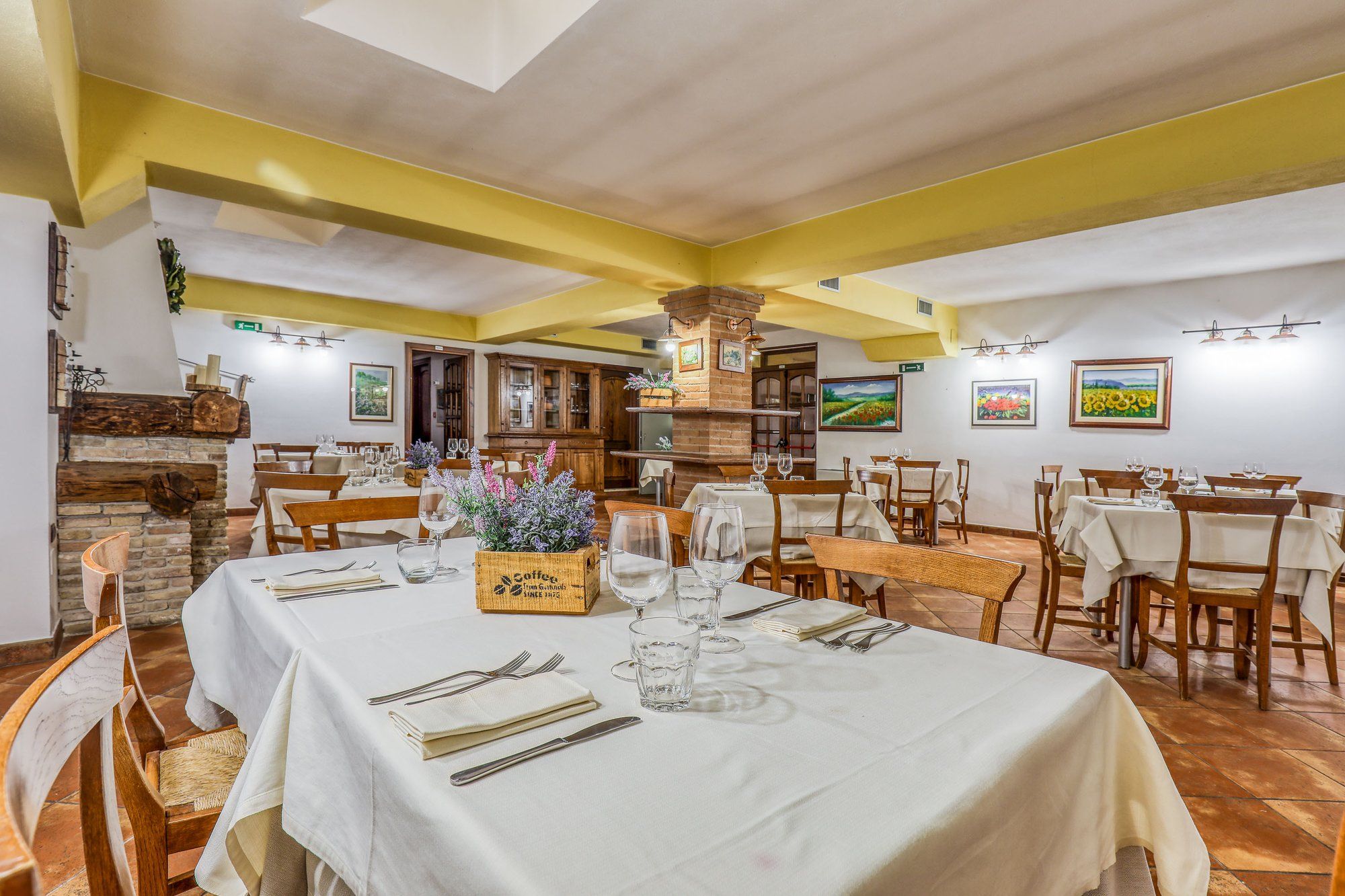 Tavoli con tovaglie bianche, calici e lavanda nella sala del ristorante
